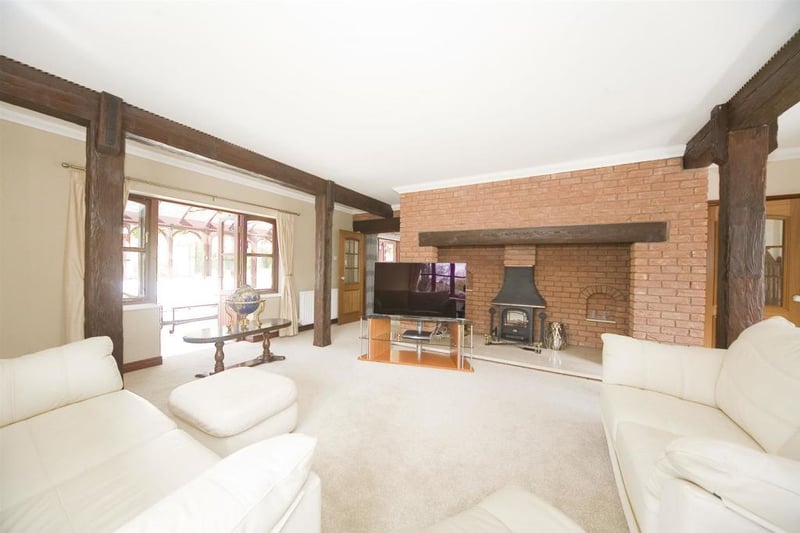 The lounge has a beautiful inglenook fireplace and an imposing decorative coving.