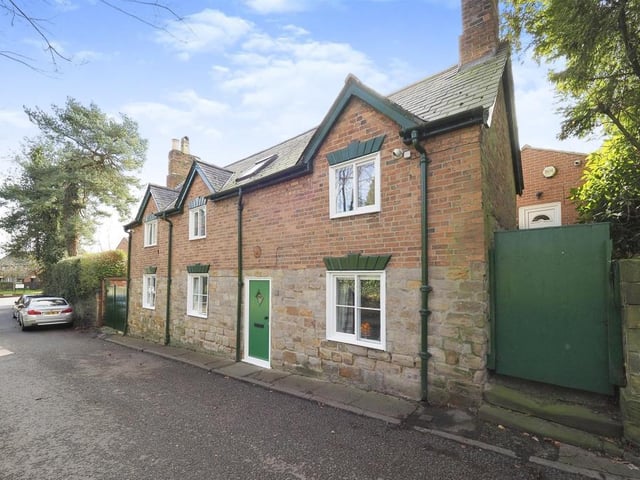 Time to step back outside now, and this street view shows how the Riddings cottage stands proud within the neighbourhood. At the far end is a gated driveway, providing parking space for multiple vehicles.