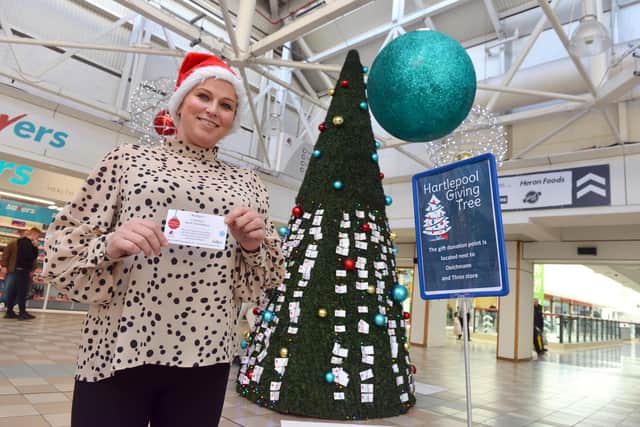 Middleton Grange Shopping Centre's operations assistant Emma Warrington by the physical Giving Tree which is now up and running.