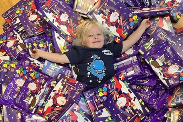 Penelope Liddle, daughter of swim teacher Olivia, with some of the donated selection boxes.