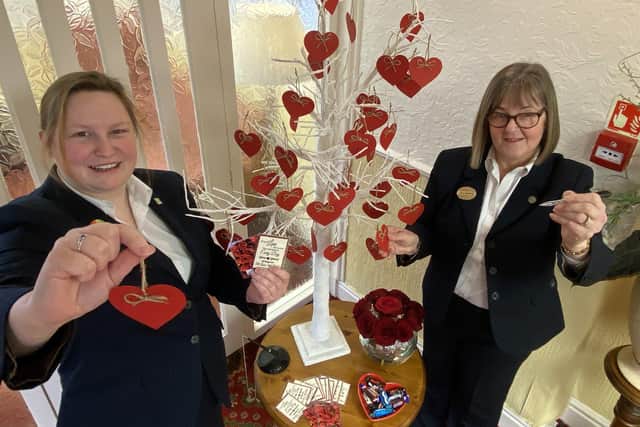 Corina Callan (left) and Julia Masshedar in front of the Valentine's display at Mansons Funeral Directors.