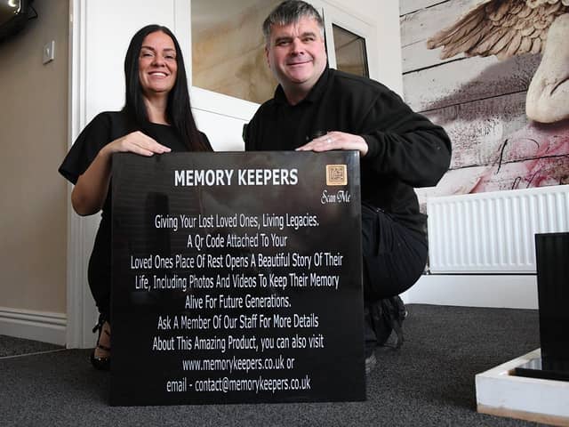 Beccy Sharp and Rikki Kinsella from Graveside Memorials, with a headstone that has a QR code. Picture by FRANK REID