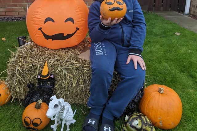 Louise Deer's son Monty with some of the Nightmare on Nuthatch Halloween decorations.