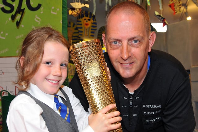 St Bega's Primary school pupil Ellie Jeffries with the Olympic Torch which was carried by Brian Baines in 2012.