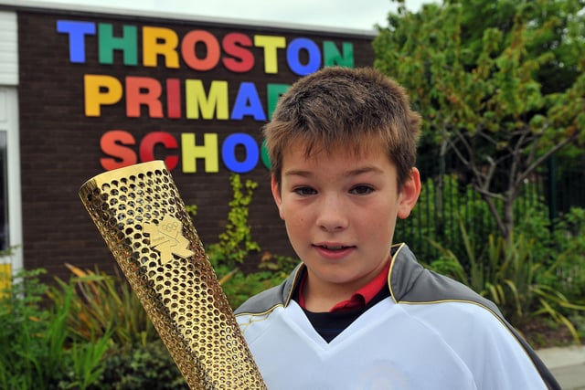 Throston Primary School pupil, Andrew Buttery, carries the Olympic Torch in 2012.