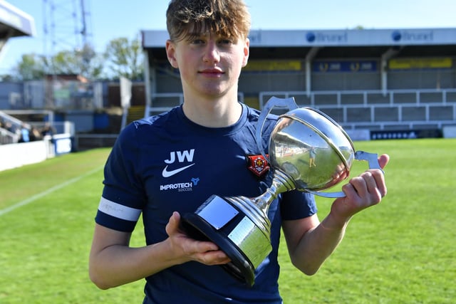 English Martyrs' captain with the trophy after his side won the year 10 final. Picture by FRANK REID