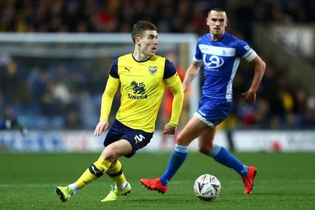 Josh Ruffels of Oxford United turns with the ball under pressure from Ryan Donaldson of Hartlepool United.