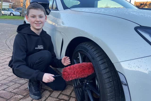 Joel Hogg washed the wheels of a car as part of the car detailing business.