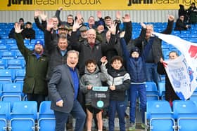 Hartlepool United president Jeff Stelling, left, poses for a picture with the travelling fans.