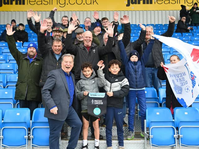 Hartlepool United president Jeff Stelling, left, poses for a picture with the travelling fans.