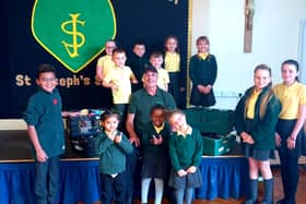 St Joseph's pupils present the collection to a representative of Hartlepool Foodbank.