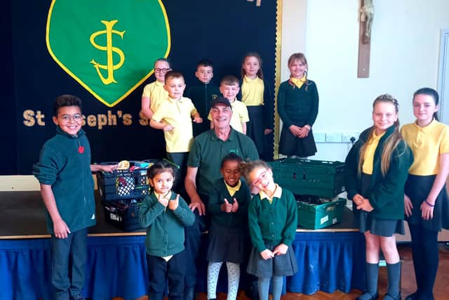 St Joseph's pupils present the collection to a representative of Hartlepool Foodbank.