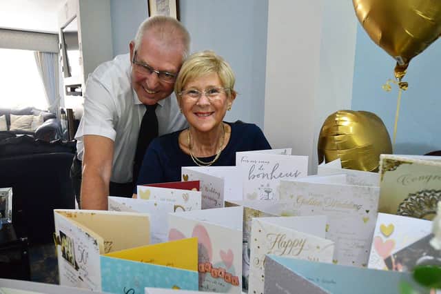 Brenda and Den Loynes with some of the many cards they received for their Golden Wedding anniversary.  Picture by FRANK REID