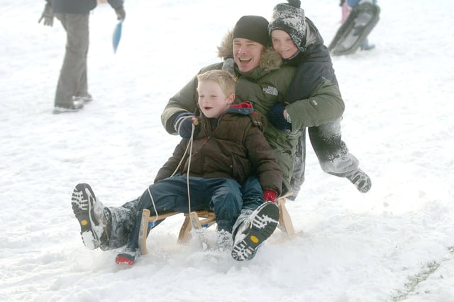 A dad and two young children hurtle down Burn Valley on a sledge in 2009.
