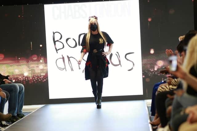 Kelly walking down the runway at the fashion show in London.