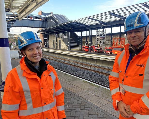 Becky Crocker, from Network Rail, and Matt Croasdale, from Northern, at Hartlepool Rail station with the new bridge and restored second platform behind them. Picture by FRANK REID