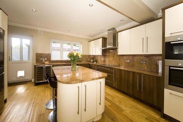 The kitchen offers a range of appliances, including a dishwasher and wine cooler.