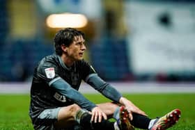 Sheffield Wednesday's Adam Reach sits on the pitch after picking up an injury against Blackburn.