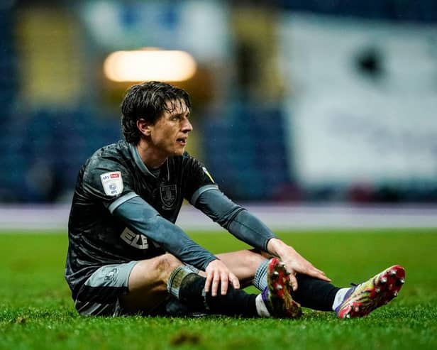 Sheffield Wednesday's Adam Reach sits on the pitch after picking up an injury against Blackburn.