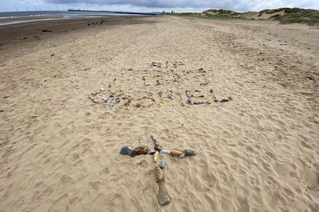 A message made in stones on the sand at Seaton Carew in memory of Gabriel Kariuki  Picture by FRANK REID
