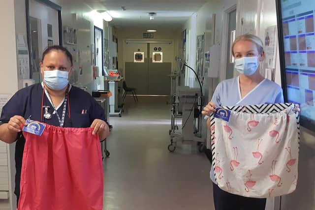Grateful hospital staff with their new scrub bags.