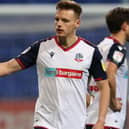BOLTON, ENGLAND - NOVEMBER 17: Liam Gordon and Tom White of Bolton Wanderers high five during the EFL Trophy match between Bolton Wanderers and Newcastle United U21 at University of Bolton Stadium on November 17, 2020 in Bolton, England. Sporting stadiums around the UK remain under strict restrictions due to the Coronavirus Pandemic as Government social distancing laws prohibit fans inside venues resulting in games being played behind closed doors. (Photo by Charlotte Tattersall/Getty Images)