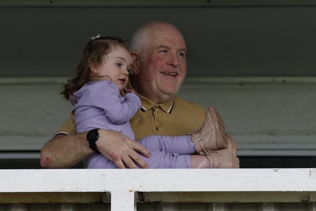 An adorable picture of a tiny girl being given a better view of the football. (Photo: Mark Fletcher | MI News)