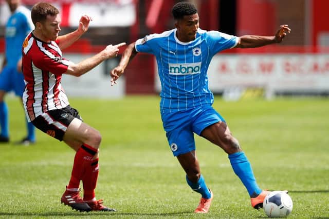 Danny Elliott of Chester in action with Tom Hannigan of Altrincham during the Vanarama National League North Play-Off match between Altrincham and Chester at  on July 19, 2020 in Altrincham, England.(Photo by Clive Brunskill/Getty Images)
