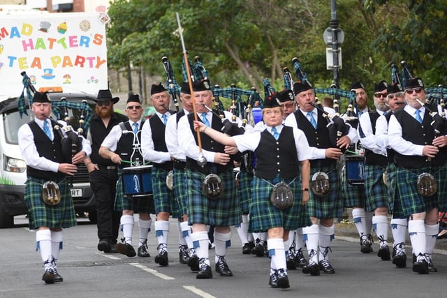 A pipe band leads the parade.