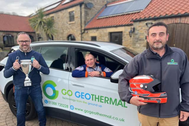 Dominic behind the wheel of a Go Geothermal electric car with Go Geothermal director Sean Sowden (left) and Mark Pearson, Go Geothermal business development manager (right).