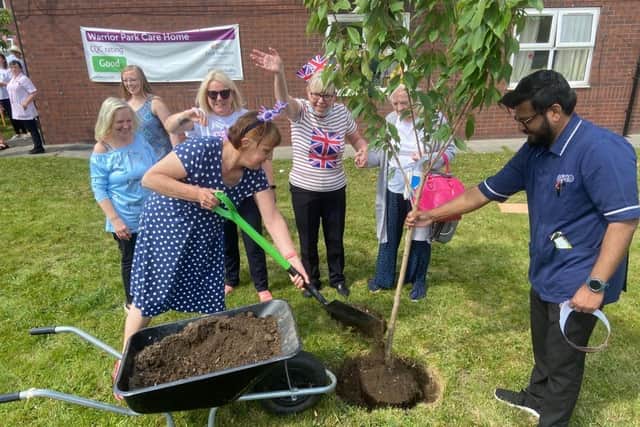 Warrior Park care home manager Valerie Halas planting a cherry blossom tree.