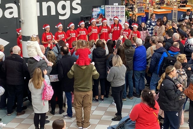 Singers from Miss Toni's Academy entertaining the crowd as they wait for Santa to arrive at Middleton Grange Shopping Centre. Picture by FRANK REID