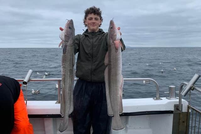 Edward Davies, 15, with some fish he caught whilst on a fishing expedition in Scotland.