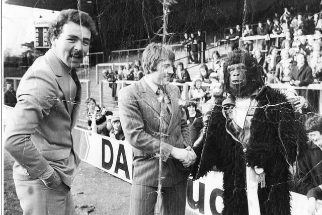 Robin Jones, as the monkey, stands alongside Hartlepool United players Bob Newton and Billy Ayre during a pre-match walkabout in January 1978.