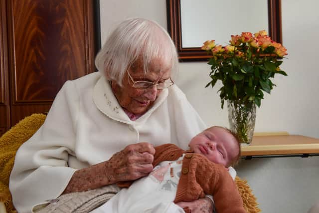102-year-old Kath Lambert holding great-great granddaughter Felicity Marshall.