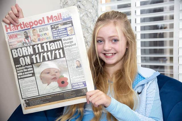 Isabelle Poppy Flounders with a copy of the Hartlepool Mail, which celebrated her birth on the 11-11-11.