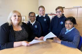 Lynnfield Primary School headteacher, Sue Sharpe, with pupils. From left: Eliza, Eva, Reece and Samra, looking at their Ofsted report.