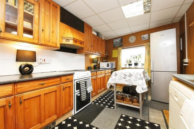 The kitchen is fitted with multiple appliances and has easy access to the yard.