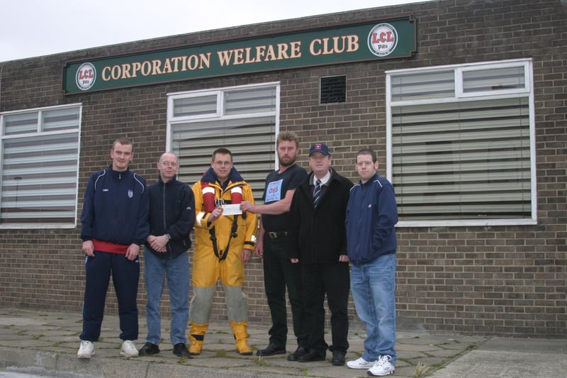 The RNLI is presented with a cheque in 2003.