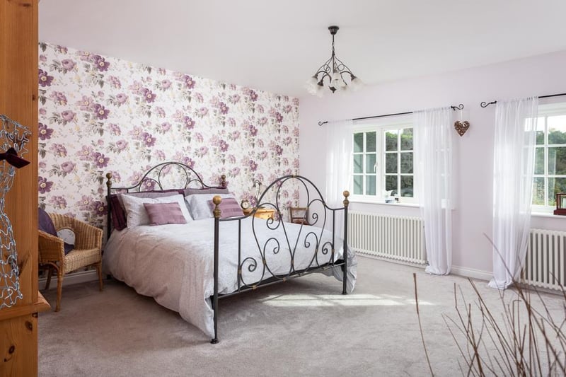 The property boasts four good sized bedrooms, including this large master room with stunning views to the front and its own luxury en-suite shower room.
