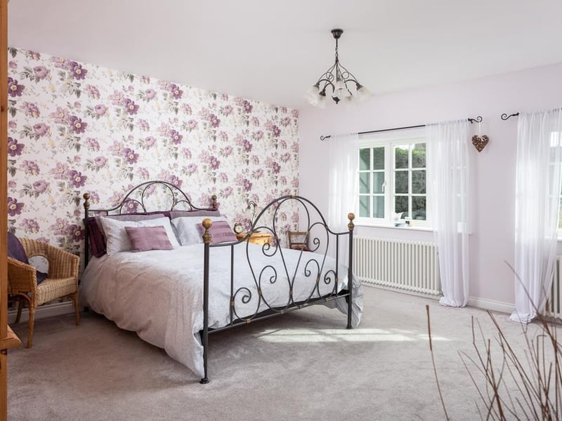 The property boasts four good sized bedrooms, including this large master room with stunning views to the front and its own luxury en-suite shower room.