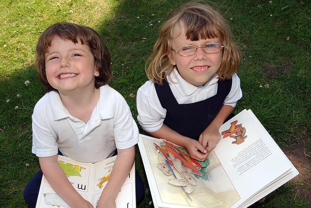 These new starters were enjoying a book in the January sun at Greatham Primary in 2003.