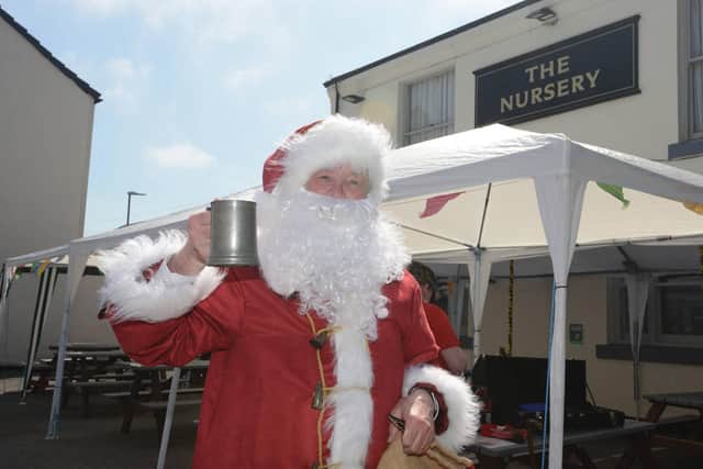 Santa raises a glass at the Nursery Inn. Picture: North News.