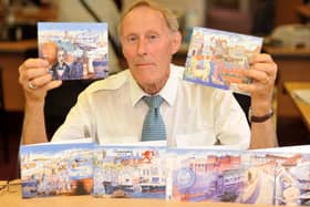 David Betson with greeting cards featuring images from the Millennium Mural.