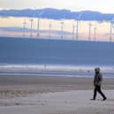 A walker on the beach at Seaton Carew.