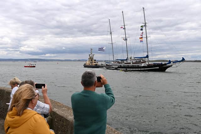 People gather to watch the early tall ships arrivals from the Pilot Pier on the Headland. Picture by Frank Reid.