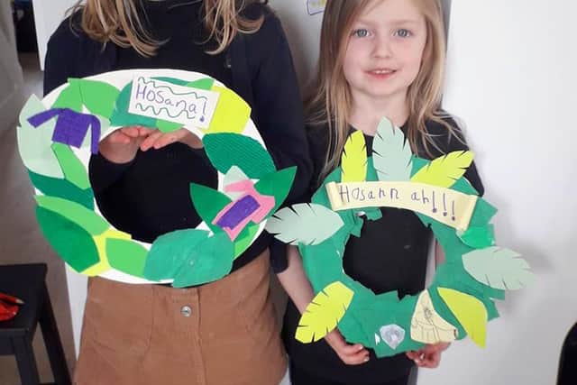 Millie and Daisy Palmer with their home made palm leaf wreaths ready to hang on their door.