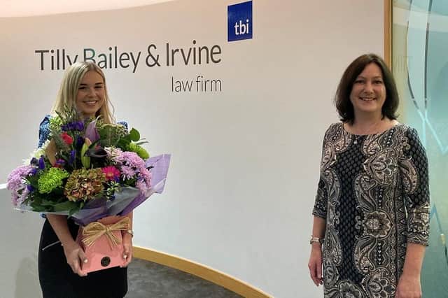 Newly qualified solicitor Jessica Inman, left, receives a congratulatory gift from Wendy Beacom, right, Head of the Private Family Law Team at Tilly Bailey & Irvine.