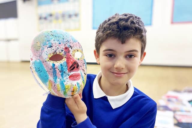 Barnard Grove primary school pupil Samuel Holtham with a face mask designed and painted by a fellow pupil at the school  Picture by FRANK REID