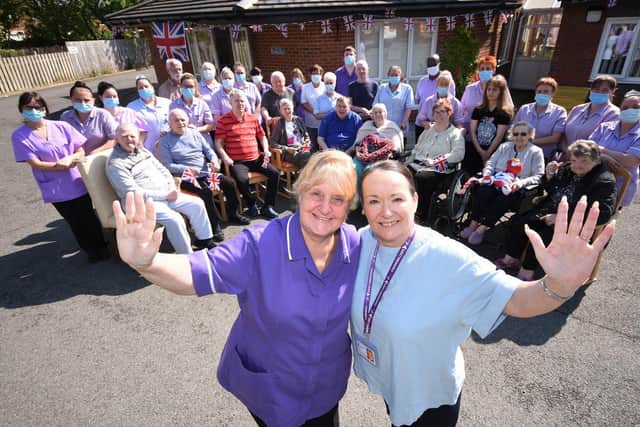 MBE awardee Julie Shield, Abbeyvale Care Centre manager, and Caron Cook,regional operations manager, celebrate with care home residents./Photo: Ian McClelland